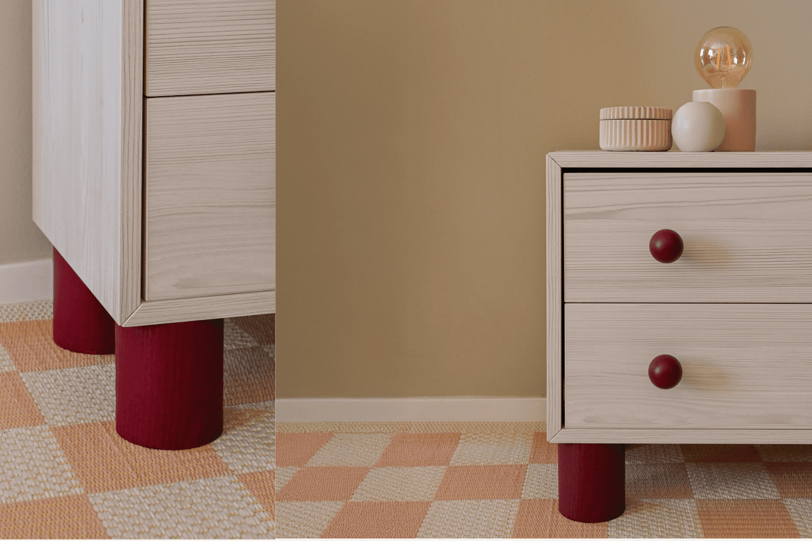 Bedside cabinet with red cylindrical legs and matching round knobs in a soft-toned room