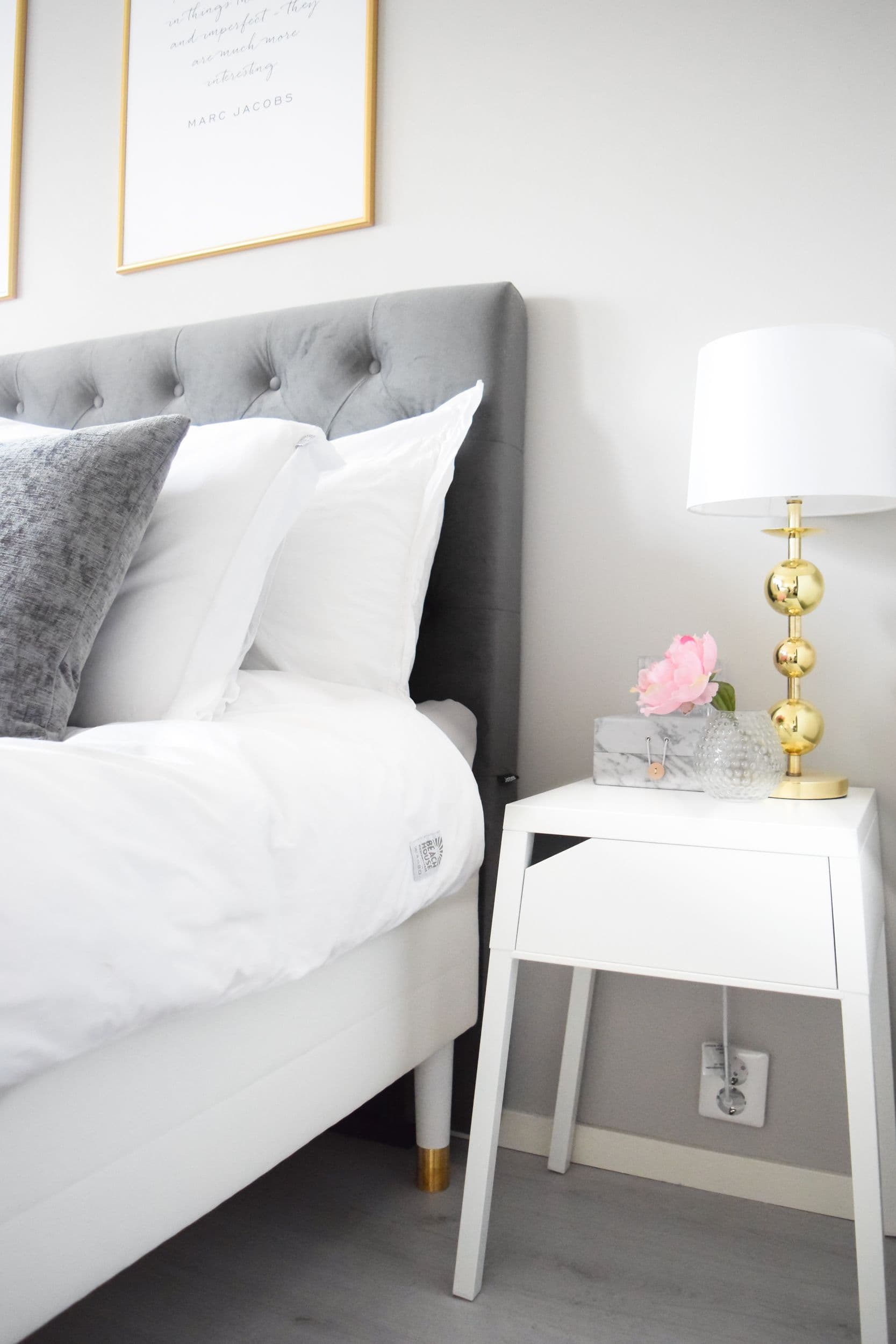 IKEA bed hack with gold metal legs creating a minimal and luxurious bedroom feel