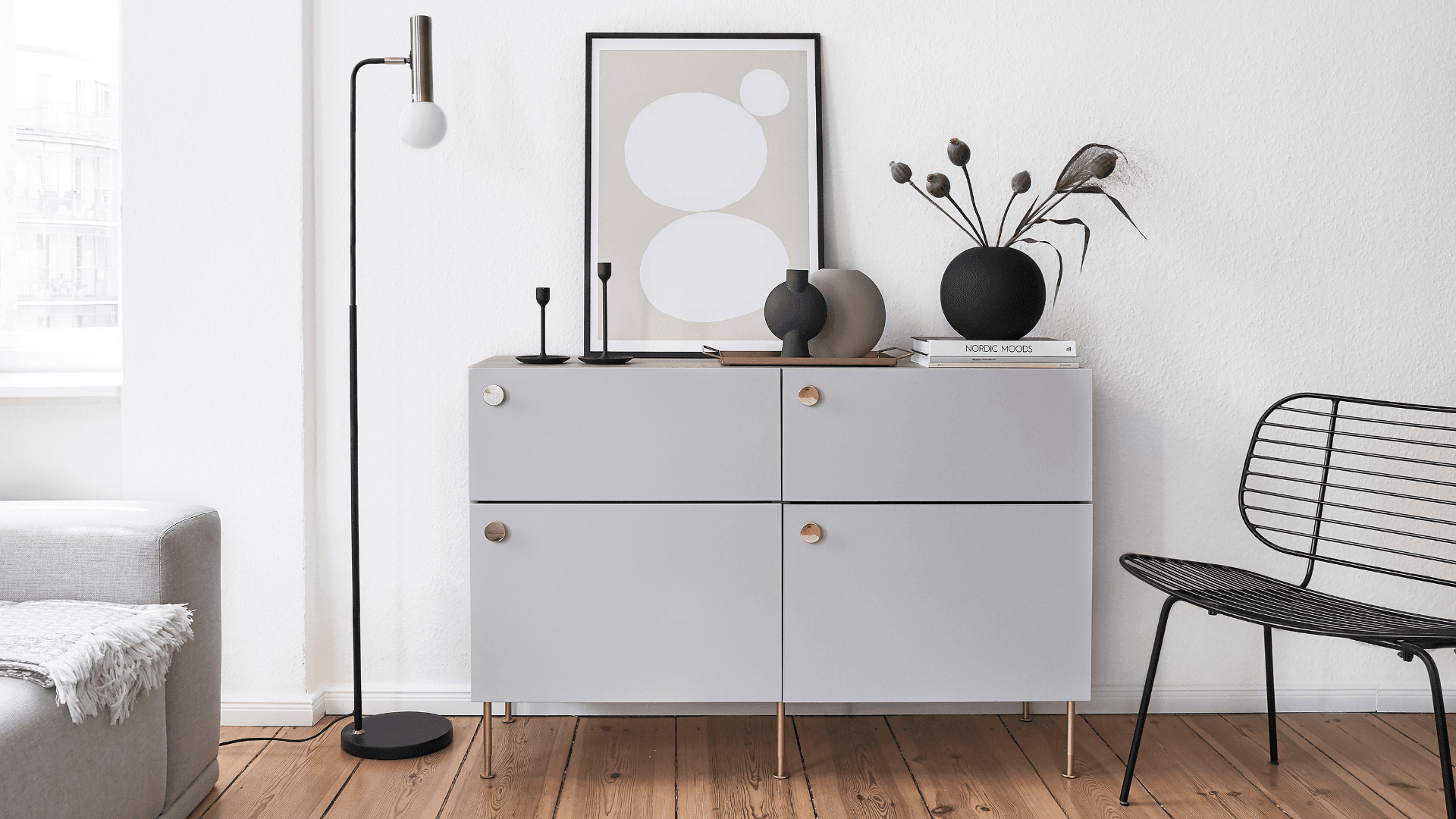Grey sideboard with brass legs and knobs by Prettypegs styled in modern Scandinavian living room.