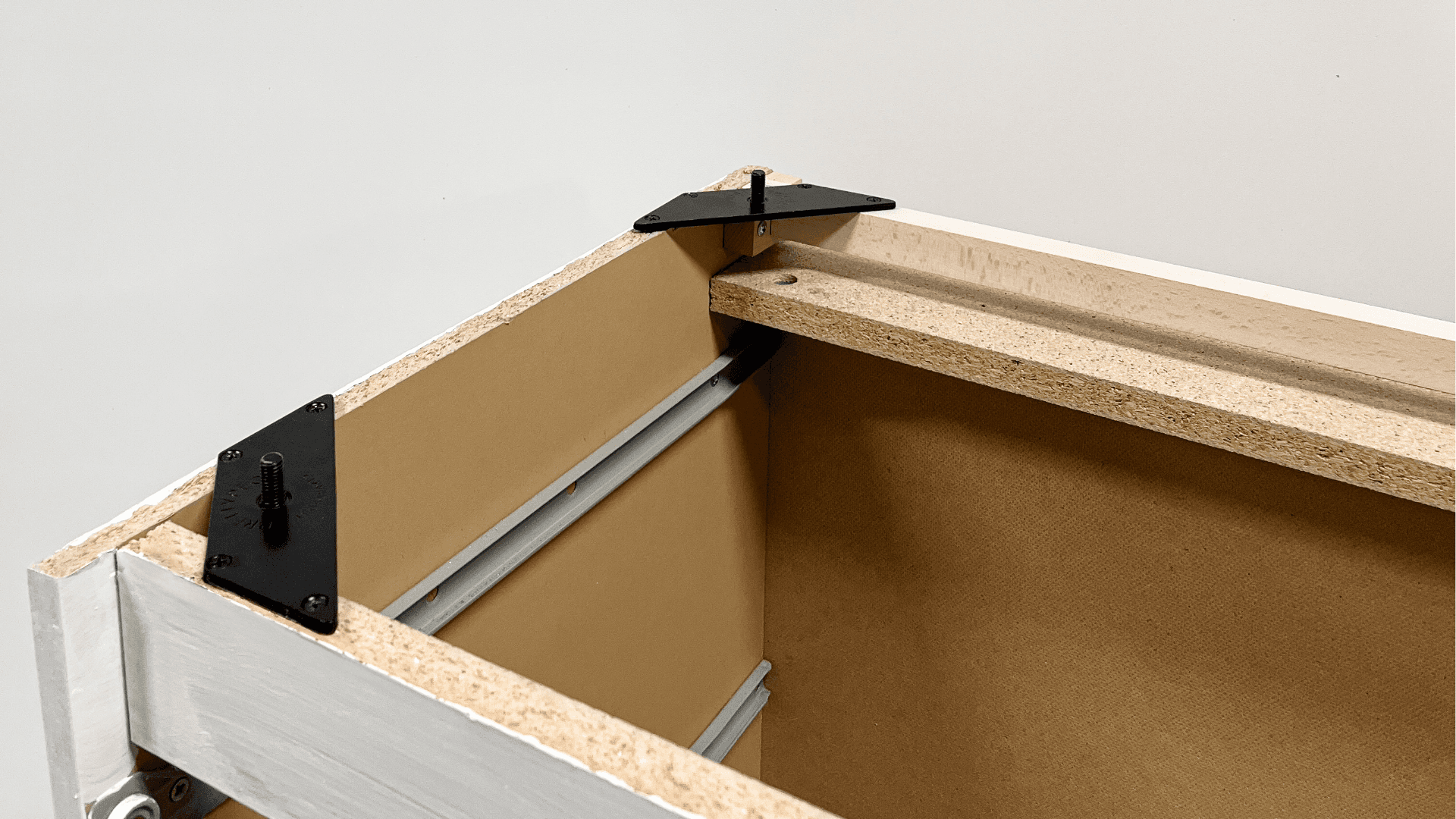 IKEA MALM dresser underside showing mounting plates and bracket support for attaching furniture legs