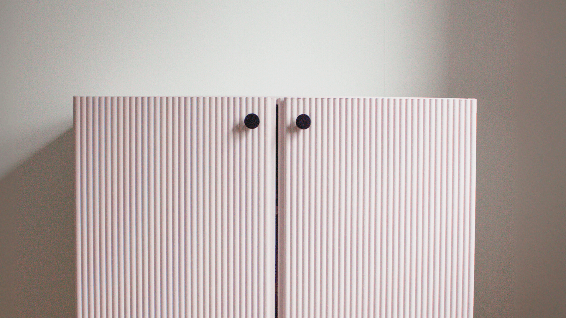 Fluted pink IKEA IVAR cabinet doors with black knobs showing the finished IVAR cabinet makeover using decorative panels