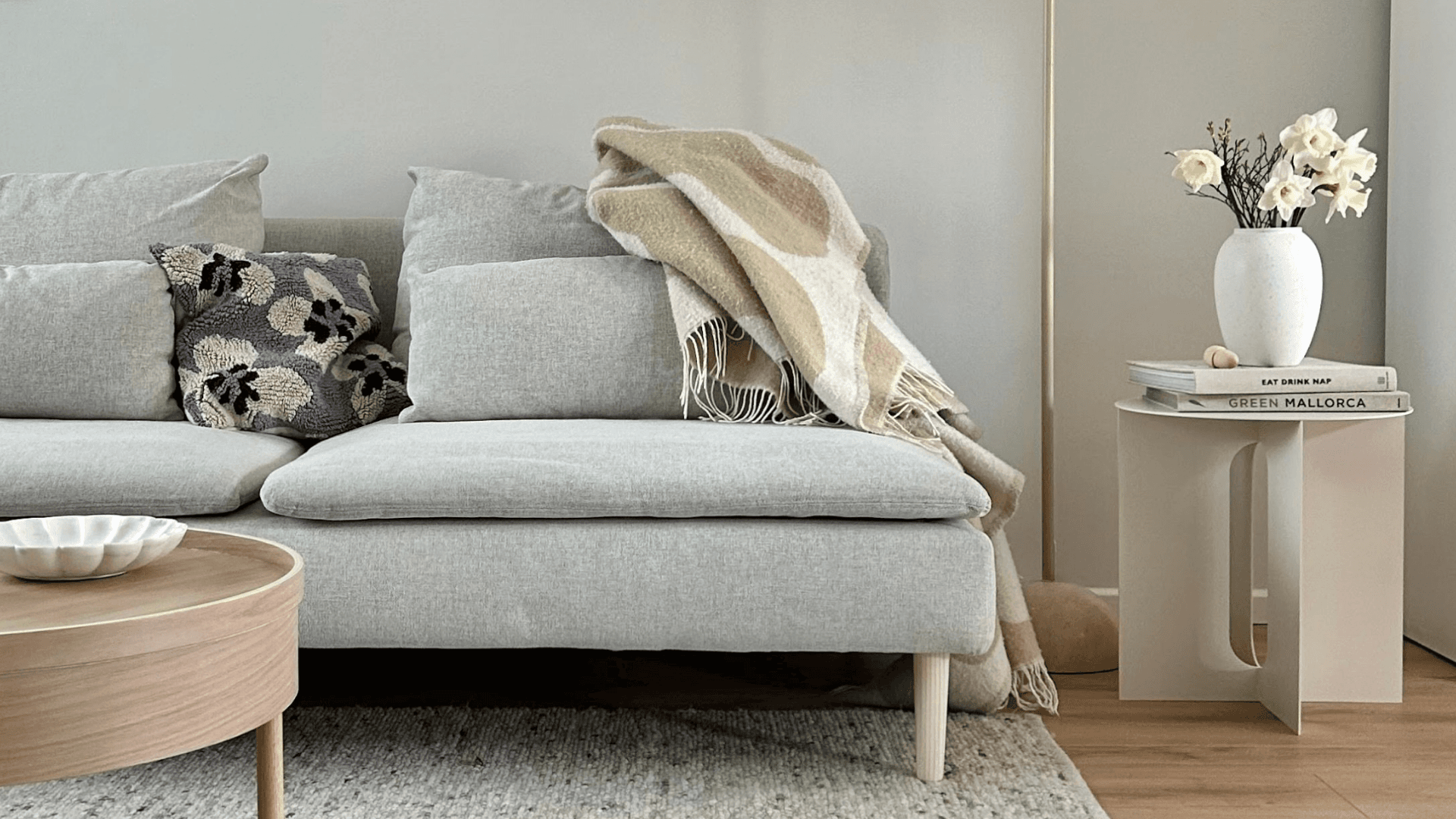 Scandinavian living room with grey sofa, wooden round table, and Prettypegs wooden legs for a minimalist look