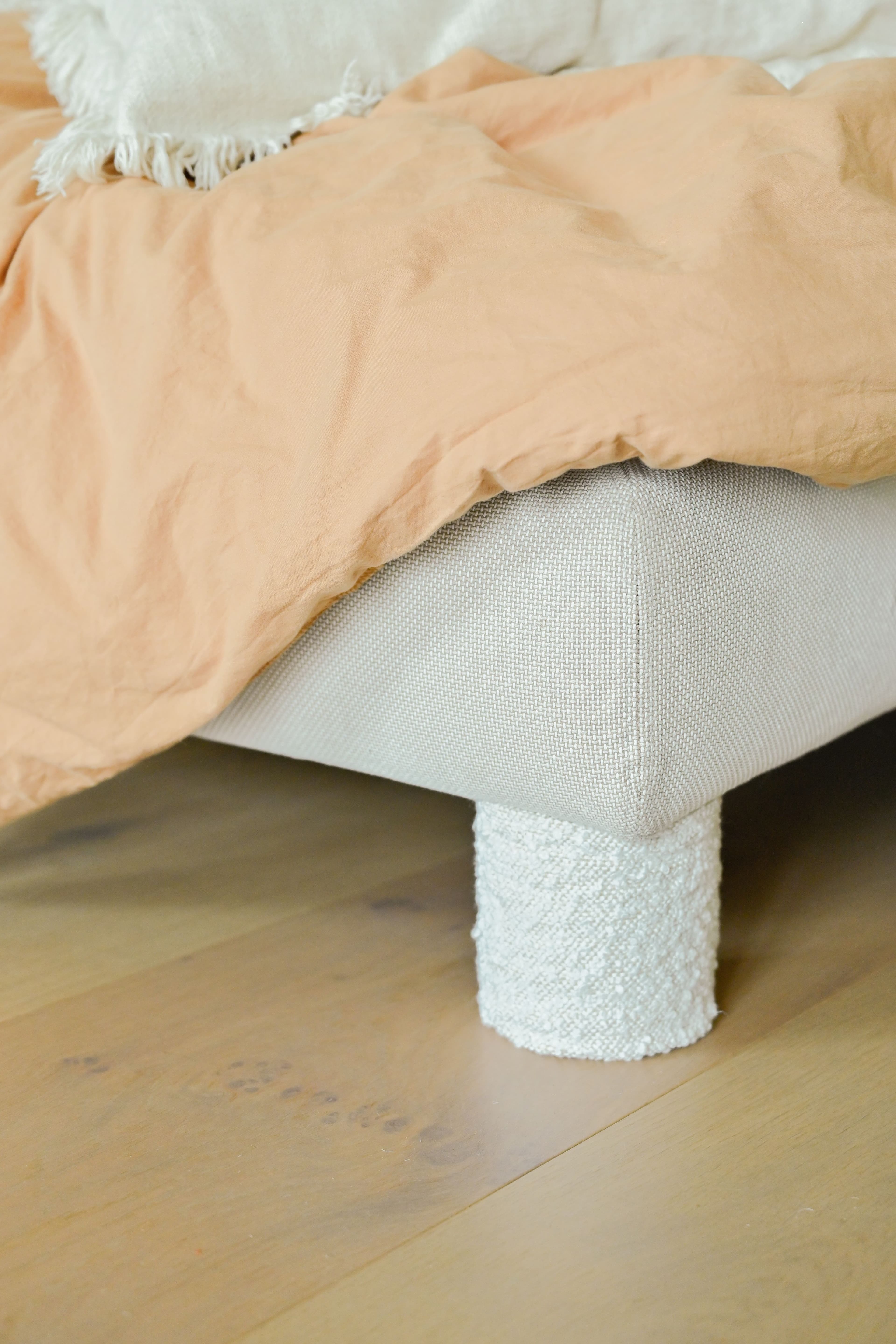 IKEA bed with textured fabric legs creating a cozy and soft bedroom look